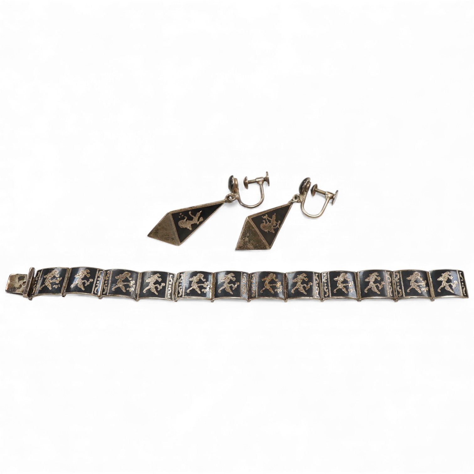 A Thai sterling and niello bracelet, 16.2cm, together with a pair of similar earrings.